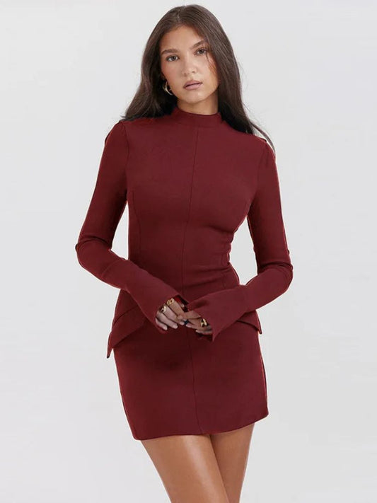 A woman wearing a Red long-sleeve pocketed mini dress with a sleek zipper closure, bodycon fit, and modern silhouette.