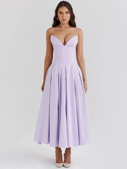 Woman wearing a lilac corset V-neck sleeveless maxi dress with chest-wrapping detail, high waist A-line skirt, fit and flare silhouette, and ankle-length design