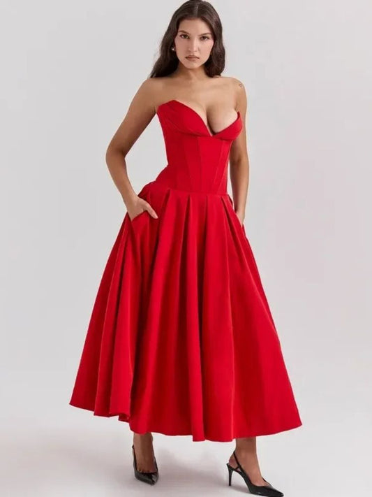 Woman wearing a red corset V-neck sleeveless maxi dress with chest-wrapping detail, high waist A-line skirt, fit and flare silhouette, and ankle-length design