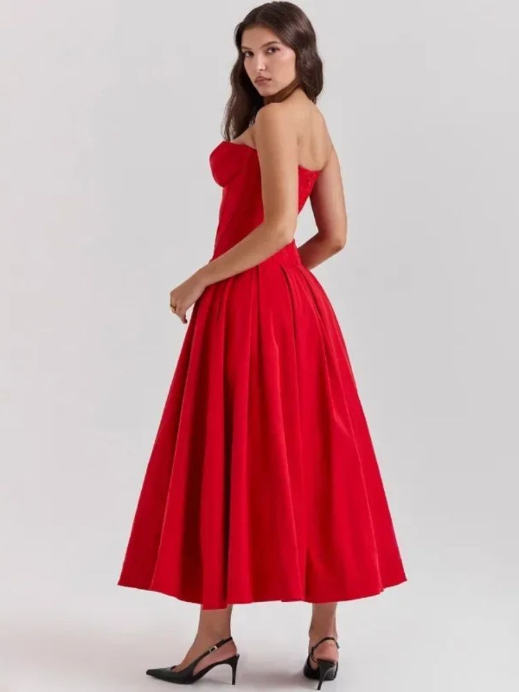 Woman wearing a red corset V-neck sleeveless maxi dress with chest-wrapping detail, high waist A-line skirt, fit and flare silhouette, and ankle-length design