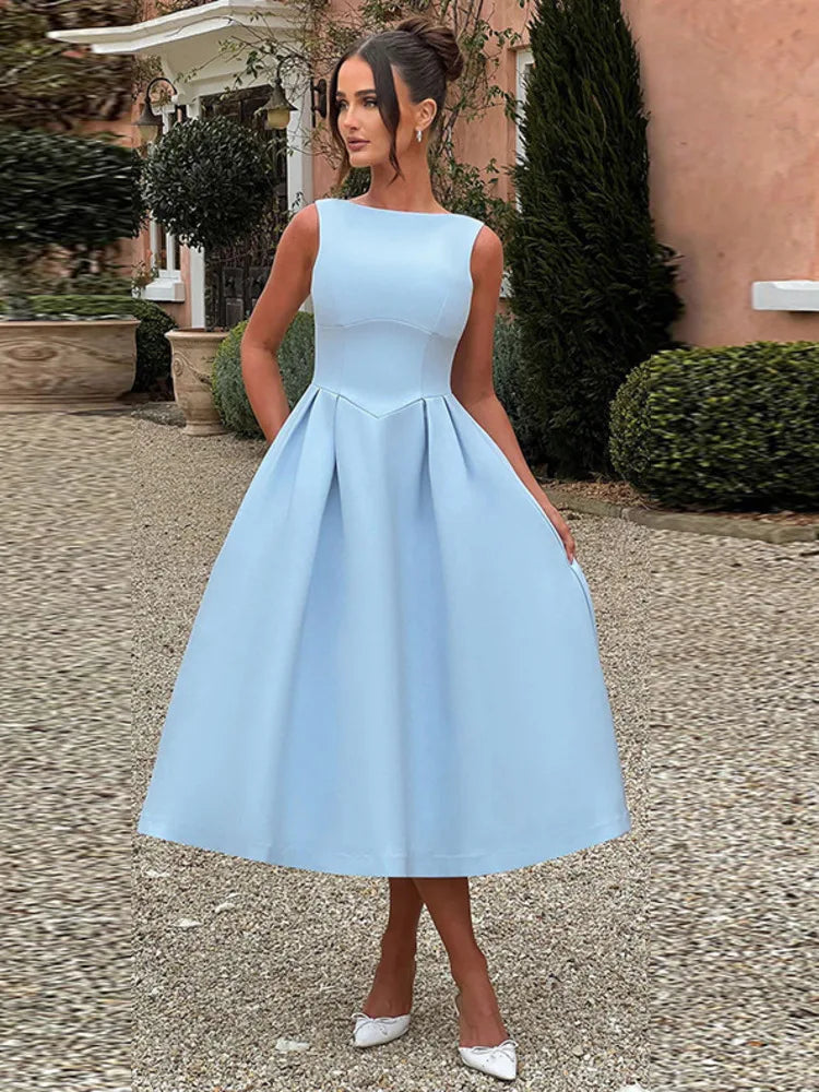 Woman wearing a light blue sleeveless Midi Dress with an A-line skirt, high boat neckline, V-shaped waist seam, low scoop back, and invisible zipper.