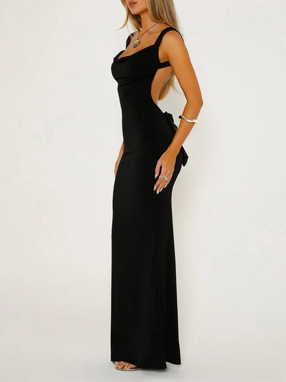 Woman wearing a black sleeveless Bodycon Maxi Dress with a Backless Design and a Satin Bow