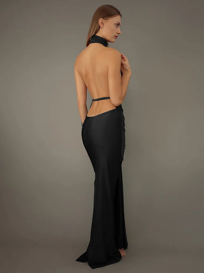 Black floor-length maxi dress with slight stretch, tank sleeves, and a turtleneck. Features a backless design and a pullover closure. Made from spandex and polyester.