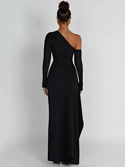 Black long-sleeve maxi dress with a thigh-high split and slight stretch. Features a sheath silhouette, backless design, a diagonal collar neckline and an A-line skirt. Made from cotton and polyester