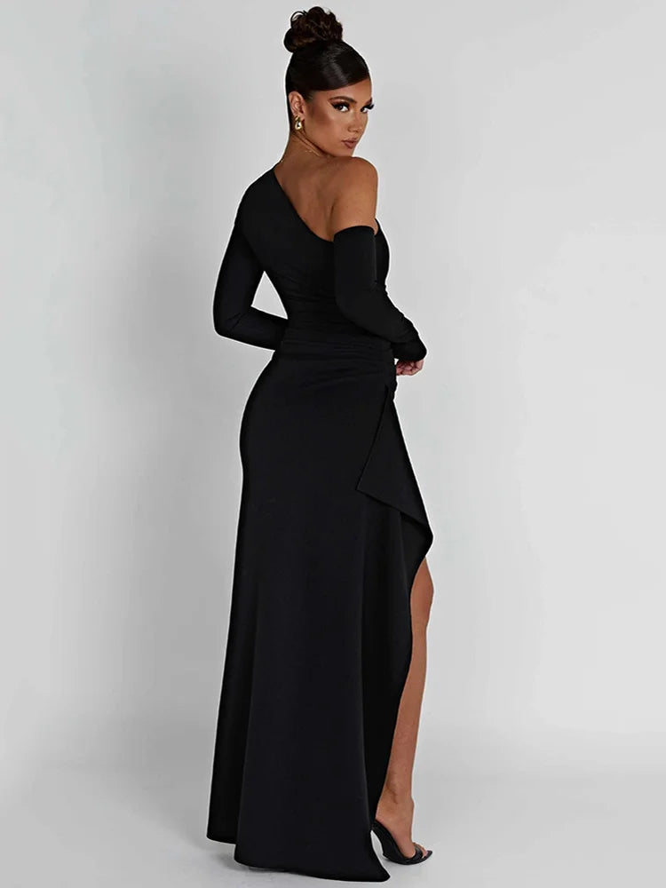 Black long-sleeve maxi dress with a thigh-high split and slight stretch. Features a sheath silhouette, backless design, a diagonal collar neckline and an A-line skirt. Made from cotton and polyester