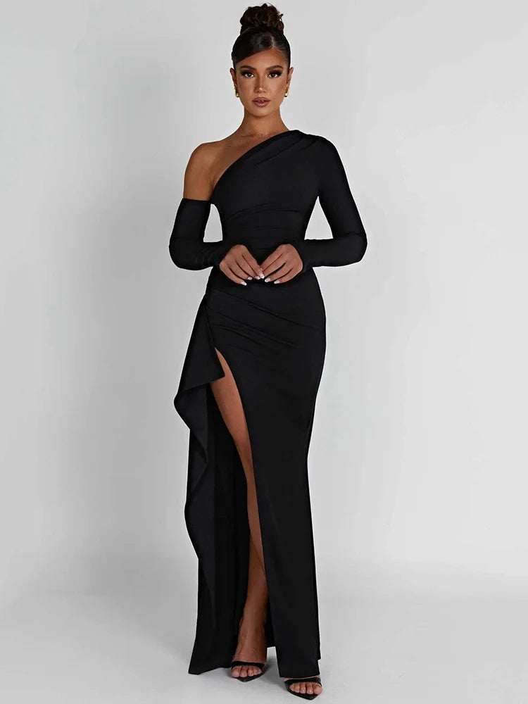 Black long-sleeve maxi dress with a thigh-high split and slight stretch. Features a sheath silhouette, backless design, a diagonal collar neckline and an A-line skirt. Made from cotton and polyester