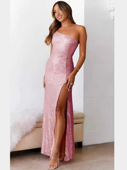 Woman wearing a full-length pink sequin dress with a one-shoulder neckline and high slit