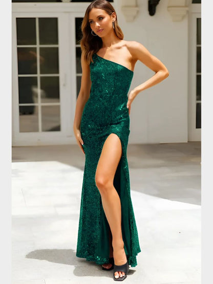 Woman wearing a full-length green sequin dress with a one-shoulder neckline and high slit