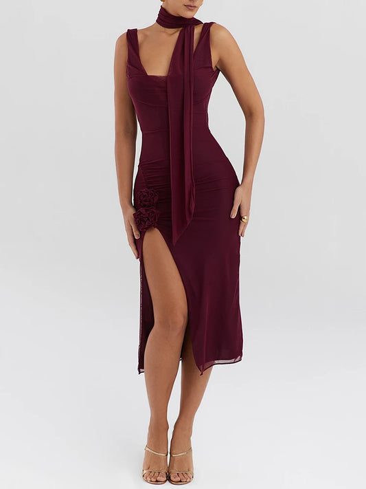 Wine red midi dress with two-layer mesh, a thigh-high split, and slight stretch. Features a strapless neckline, tank sleeves, flower decoration, and mid-calf length. Made from mesh, spandex, and polyester with a zipper closure.