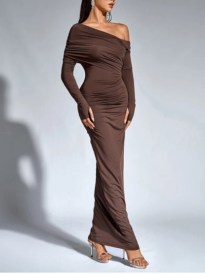 Woman wearing a brown bodycon maxi dress with long sleeve, asymmetric neck, one shoulder, and ruched detailing