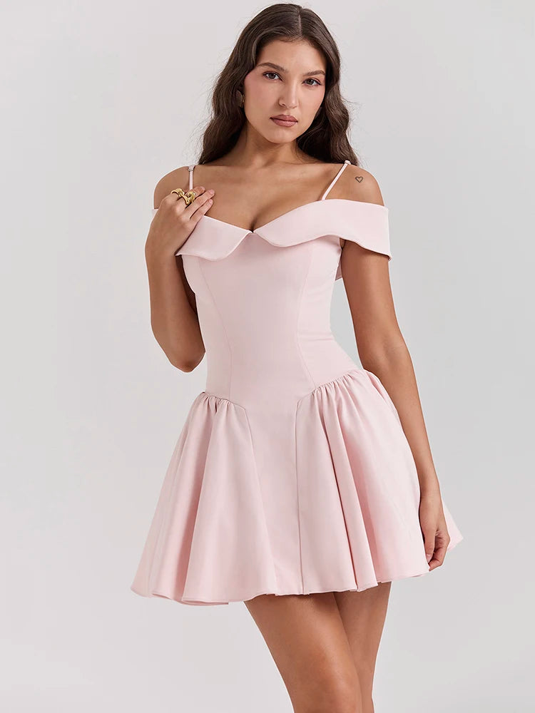 Pink mini dress with an A-line silhouette, off-shoulder design, and medium stretch. Features a sheath fit, strapless neckline, spaghetti straps, and above-knee length. Made from spandex and polyester with a zipper closure.