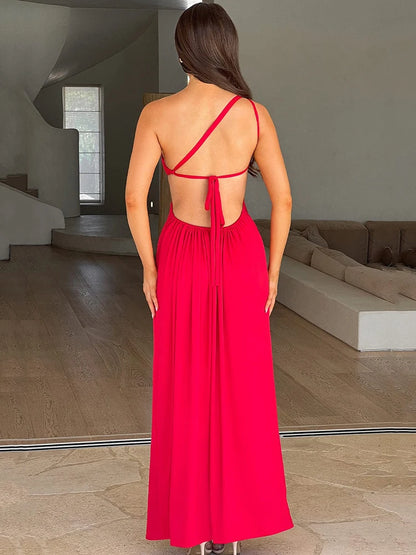 Woman wearing a rose red one shoulder backless maxi dress with a diagonal collar, off-shoulder design, sleeveless style, and high split 