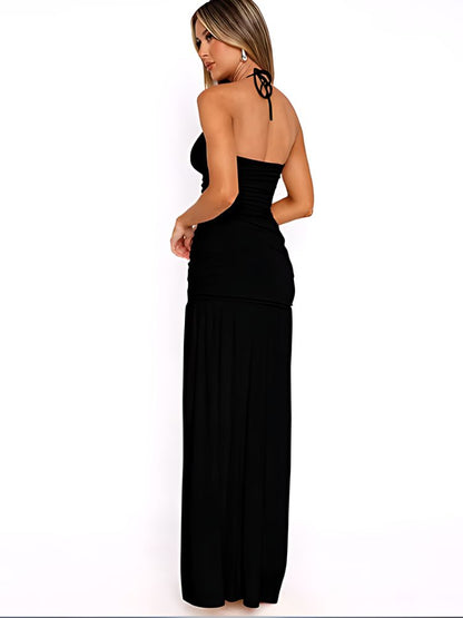 Woman wearing a Maxi Dress in black with a ruched bodice, halter neckline, and thigh-high slit, modeled from different angles