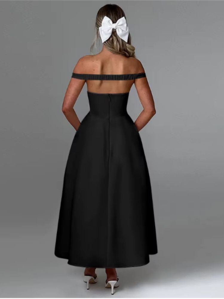 A woman wearing a Black off shoulder midaxi dress with a pleated skirt