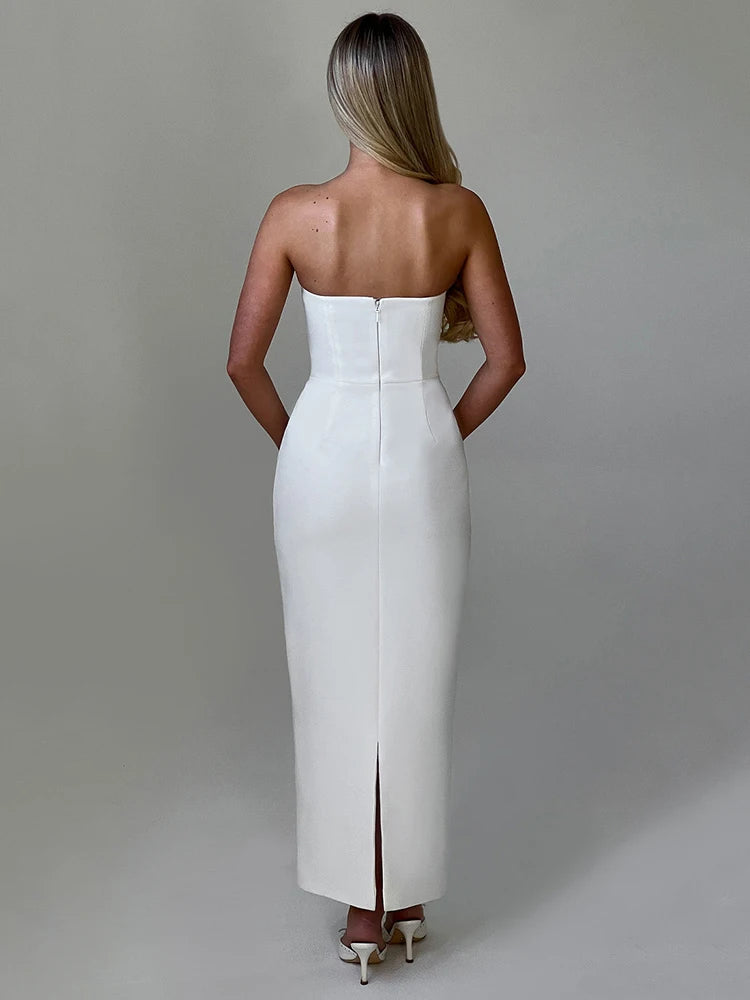 Woman wearing a white off-shoulder strapless backless bodycon maxi dress with a back split and pocket detail