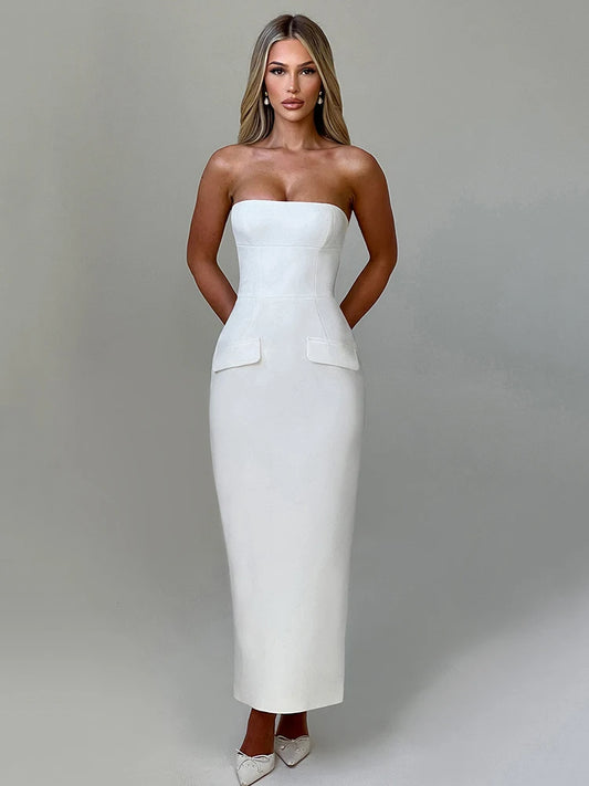 Woman wearing a white off-shoulder strapless backless bodycon maxi dress with a back split and pocket detail