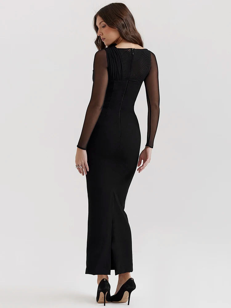 Black bodycon maxi dress with sheer long sleeves and hollow-out details.