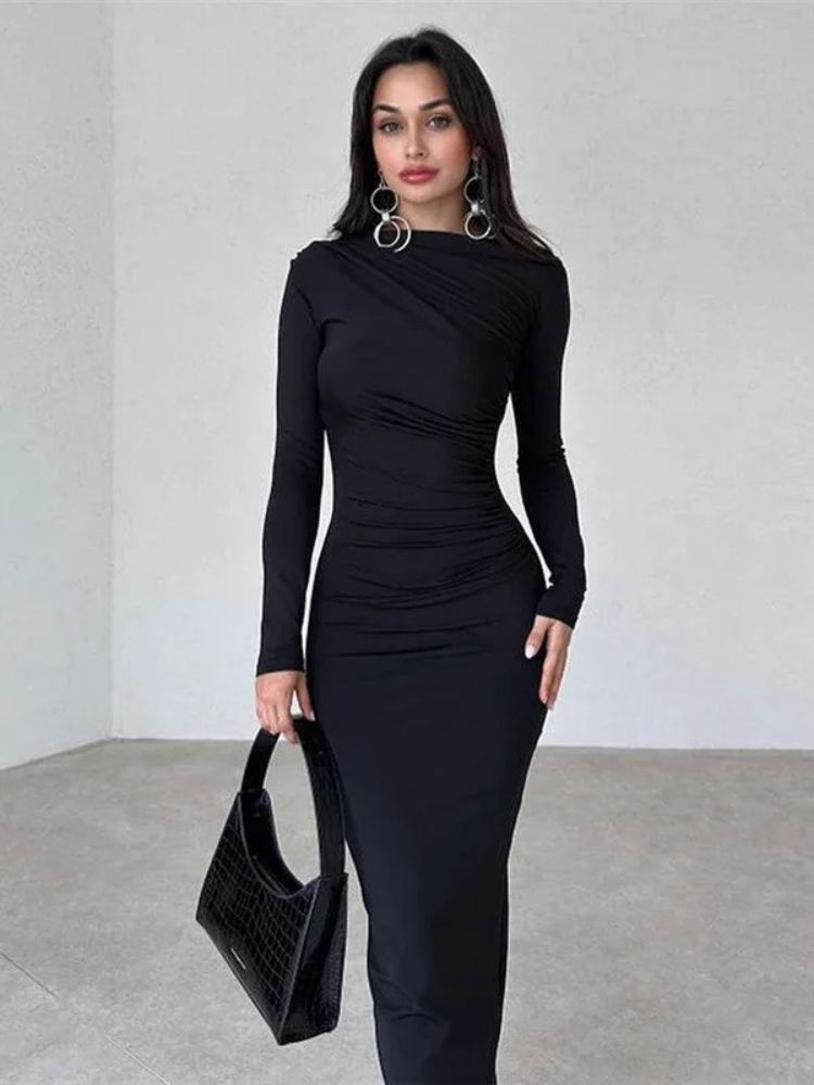 Woman wearing a black ruched bodycon maxi dress with long sleeves, O-neck, and ankle-length design